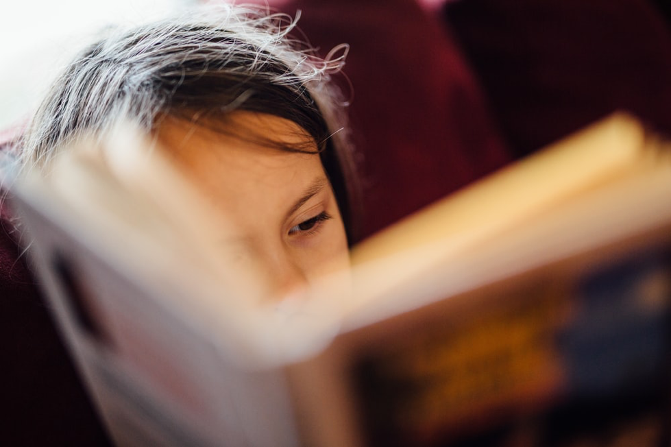 A girl being read a book