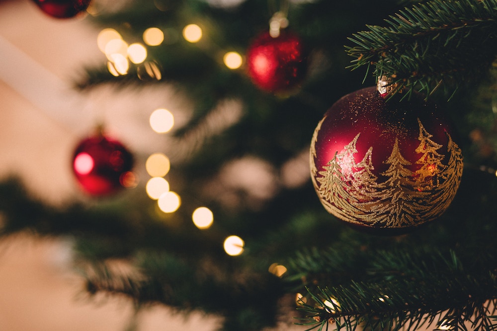 A Christmas tree with red baubles on it