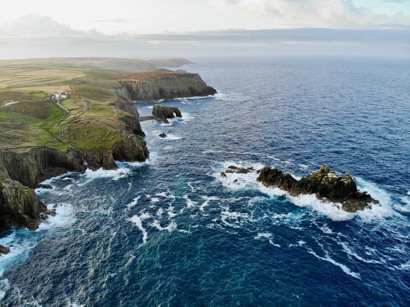 An aerial shot of the sea and cliffs off Land’s End