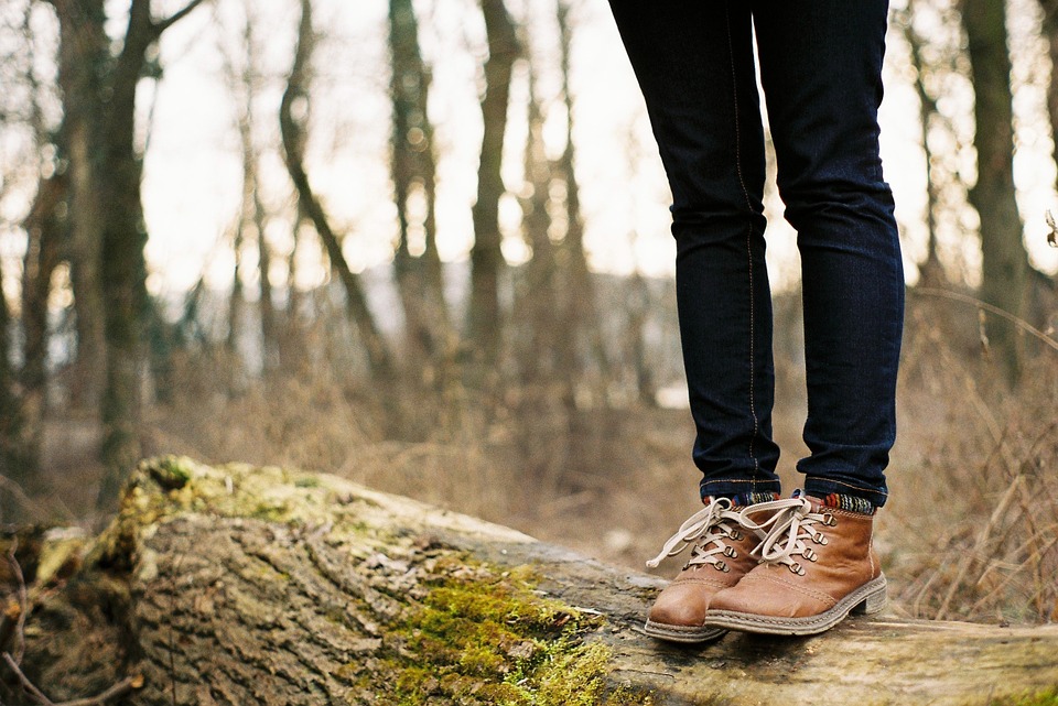 A woman standing on a fallen tree