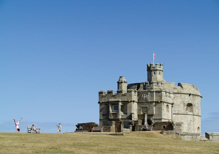 Family play outside Pendennis Castle in Falmouth, Cornwall 