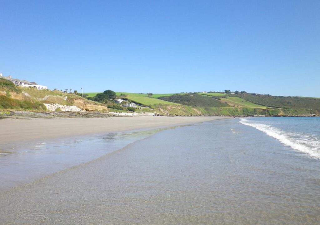 The flat beach and calm waves at Carne Beach