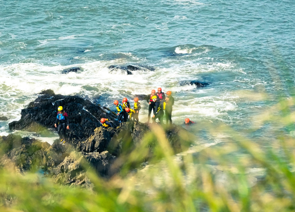 A group taking part in coasteering 