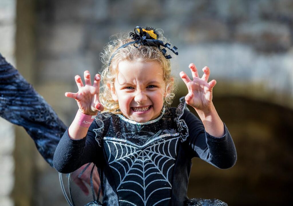 A girl in a Halloween costume pulling a face