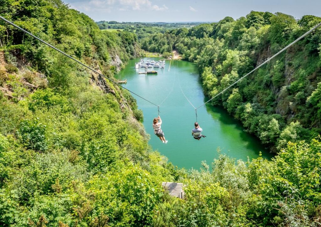 Two people on the zip wire at Adrenalin Quarry