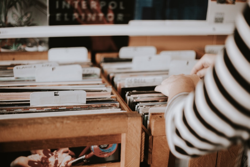 A person looking at records in a shop