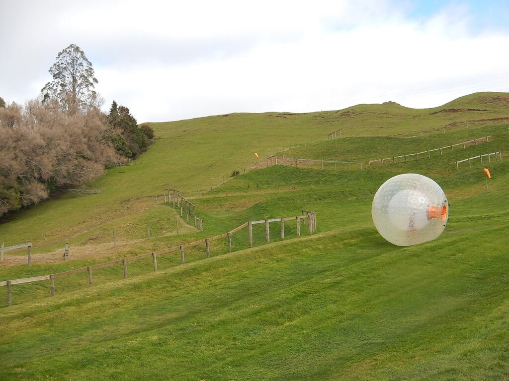 A zorbing ball rolling down a hill